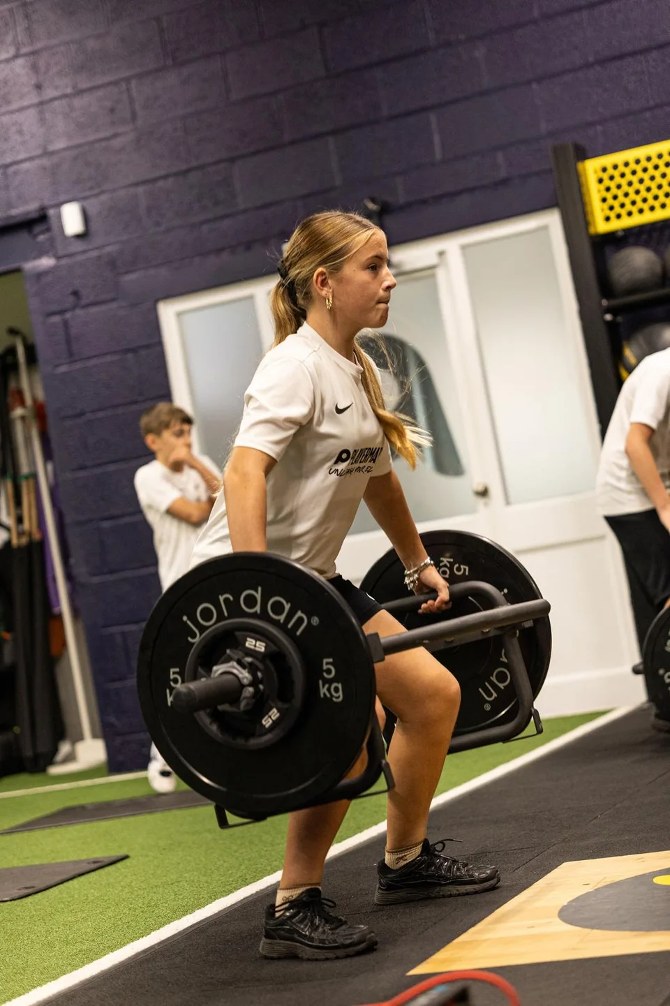Young athlete lifting a trap bar in the Playermade gym