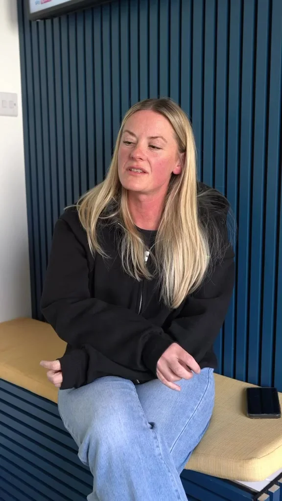 A parent discussing her daughter’s gym and football coaching at the club