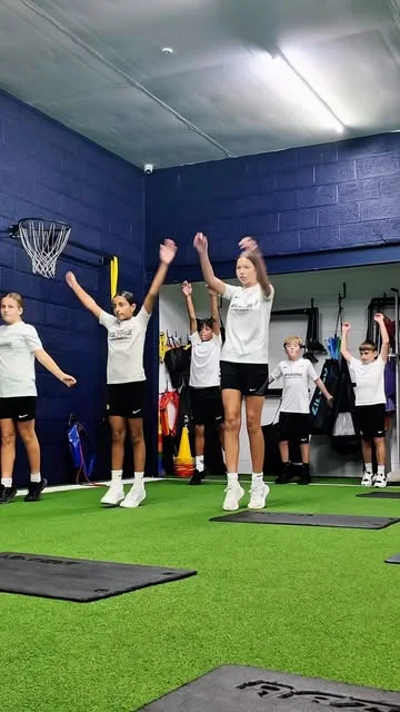 Junior athletes practising jumps together in the Playermade gym