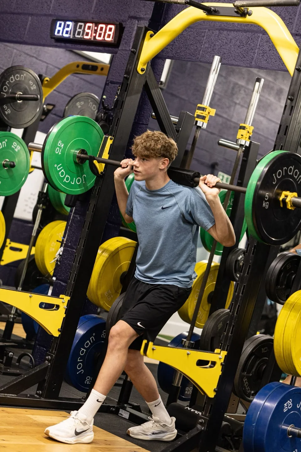 An athlete training with a barbell in the Playermade gym