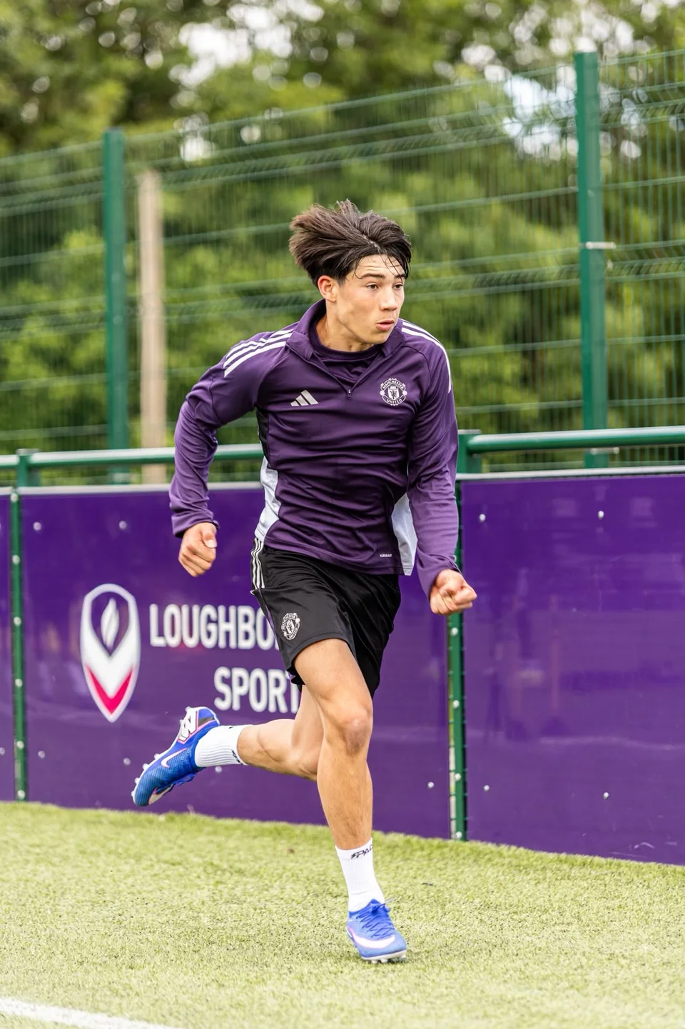A footballer accelerating during a pitch training drill