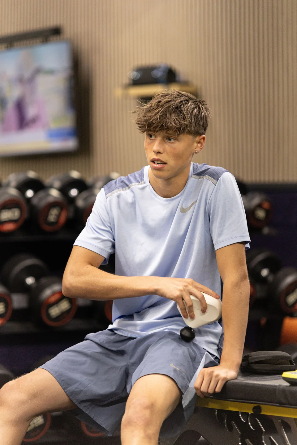 An athlete using a recovery device after gym training